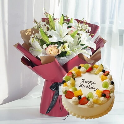 3 Stems of Champagne Roses & 3 Stems of Multi-bloom White Lilies + Round Fruit Cake