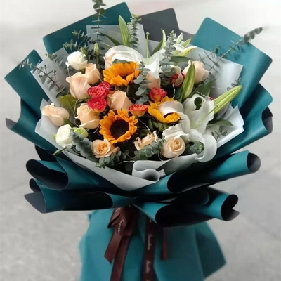 11 Stems of Champagne Roses, 3 Stems of Sunflowers & 2 Stems of Multi-bloom White Lilies